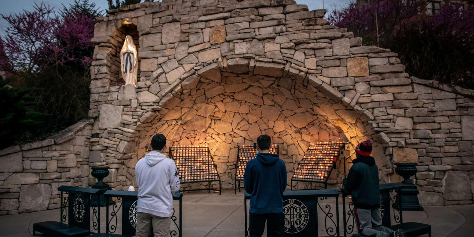 Students pray at Mary's Grotto